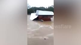 Flash flood sweeps away home as monsoon storms batter southern Philippines