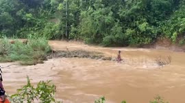 Farmer and cow rescued from raging flood in Thailand