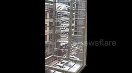 Snow chunks plunge from building roof like waterfall in China