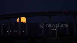 Wolf Moon rises over Kent's Sheppey Crossing, UK