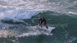 UK Weather, Surfers ride the huge waves generated by Atlantic Weather system, Great Western Beach, Newquay, Cornwall, UK
