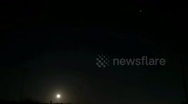 The International Space Station seen as the Wolf Moon rises over East London