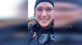 US Officer Struggles on Icy Street of Arkansas City, KS, USA