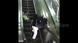 Heroic woman uses body to save elderly man tumbling down escalator in China