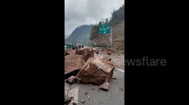Boulder tumbling down mountain hits passing car, injuring 1 in China