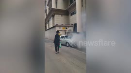 Motorists help control fire from overheating parked car