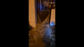 Helpless man stranded outside as bungalow is filled with relentless floodwater