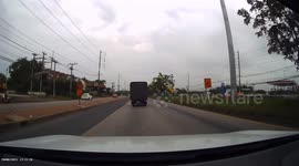 Spare tire falls from truck on Thai highway