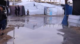 Locals trudge through thick mud at refugee camp in Gaza's Rafah