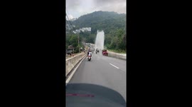 Burst water pipe sprays drivers on road in Thailand
