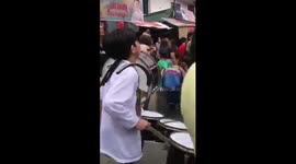 Young musician plays marching drums at a festival in the Philippines