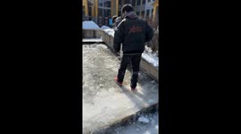 Student Slides on Slippery Frozen Slope Like a Ballet in China