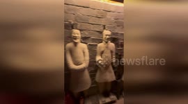 Puzzled woman admires Terracotta Army-themed hotel room