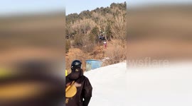 Young girl rescued after dangling from stranded cable car at ski resort