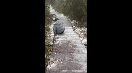 Winter hiking adventure turns icy: friends' slippery descent in Zhejiang, China