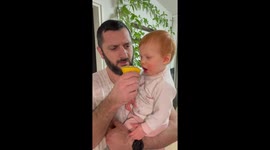 Toddler determined to overcome bitterness of lemon