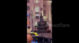 UK: Man Climbs Eros Status In London’s Piccadilly Circus 2