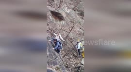 Hiker miraculously survives falling off a steep cliff and into a river