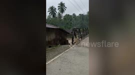 Floods batter bridge as monsoon batters southern Philippines