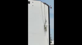 Construction worker hanging off building tangled in netting rescued in Peru