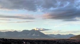 Camera Pan of Cityscape with a Mountain and a Rain Storm in the Background