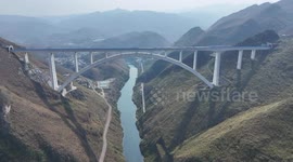 Maintenance workers safeguard railway bridge in China as Spring Festival nears