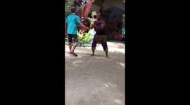 A man uses his mouth to peel a coconut super quickly
