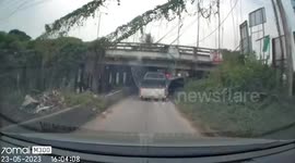 Modified pickup truck with cage rams low-lying bridge