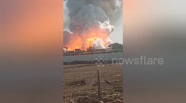 Smoke rises from the scene of a deadly illegal firecracker factory explosion in central India