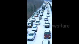 Drone footage showcases thousands stranded on highway as severe weather grips central China