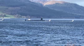 UK submarine heading up Loch Long in Argyll Scotland with support
