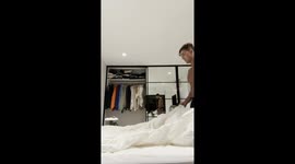 Two-month-old kitten playfully hinders bed-making in Sydney, Australia
