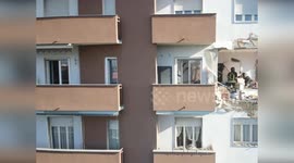 Firefighters inspect damage following apartment explosion in Milan