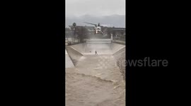 Man rescued from surging river after diving in to rescue his dog