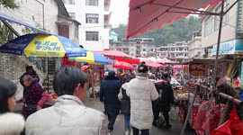 Villagers buy Lunar New Year goods at a market in Enshi, China
