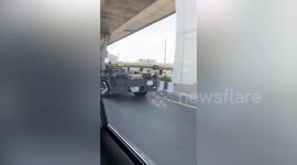 Driver in helmet drives large modified vehicle without frame