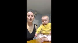 Adorable baby can't stop giggling at mum slamming shoes on table