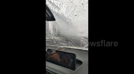 Falling ice from bridge strikes moving car's windscreen in central China