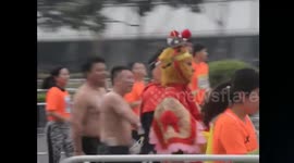 Chinese marathon runners take selfies with cosplaying participants