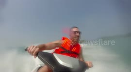 Man falls off jet-ski very suddenly