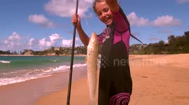 Young girl catches a huge whiting (fish) off Terrigal beach