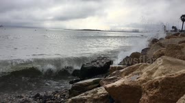 Waves crashing over rocks in slow motion.