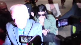 Kim and Kourtney Kardashian cause a paparazzi firestorm as they arrive at LAX Airport