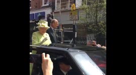 Queen waves to admirers while driving through Windsor