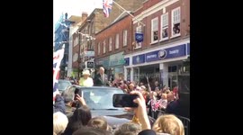 Queen waves to admirers while driving through Windsor