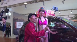 82-year-old man takes selfies with all models on auto show