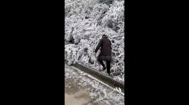 Winter mishap: snowy pose turns slippery in Zhejiang's frosty stumble