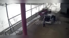 Shed roof weighed down by snow collapses narrowly missing driver