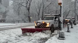 Snow plows and pedestrians battle snow storm in New York City