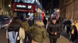 Palestine protester yells at a passer-by holding two Union Jack Flags